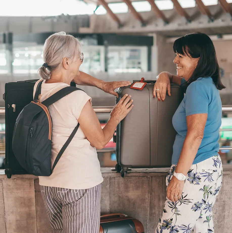 Friends talking around baggages