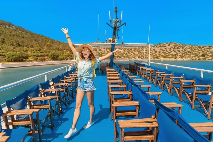 Happy Asian woman in Hat enjoying travel and vacation on cruise ship. Tourist Girl on the deck