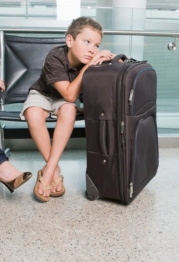 Kid waiting with his luggage