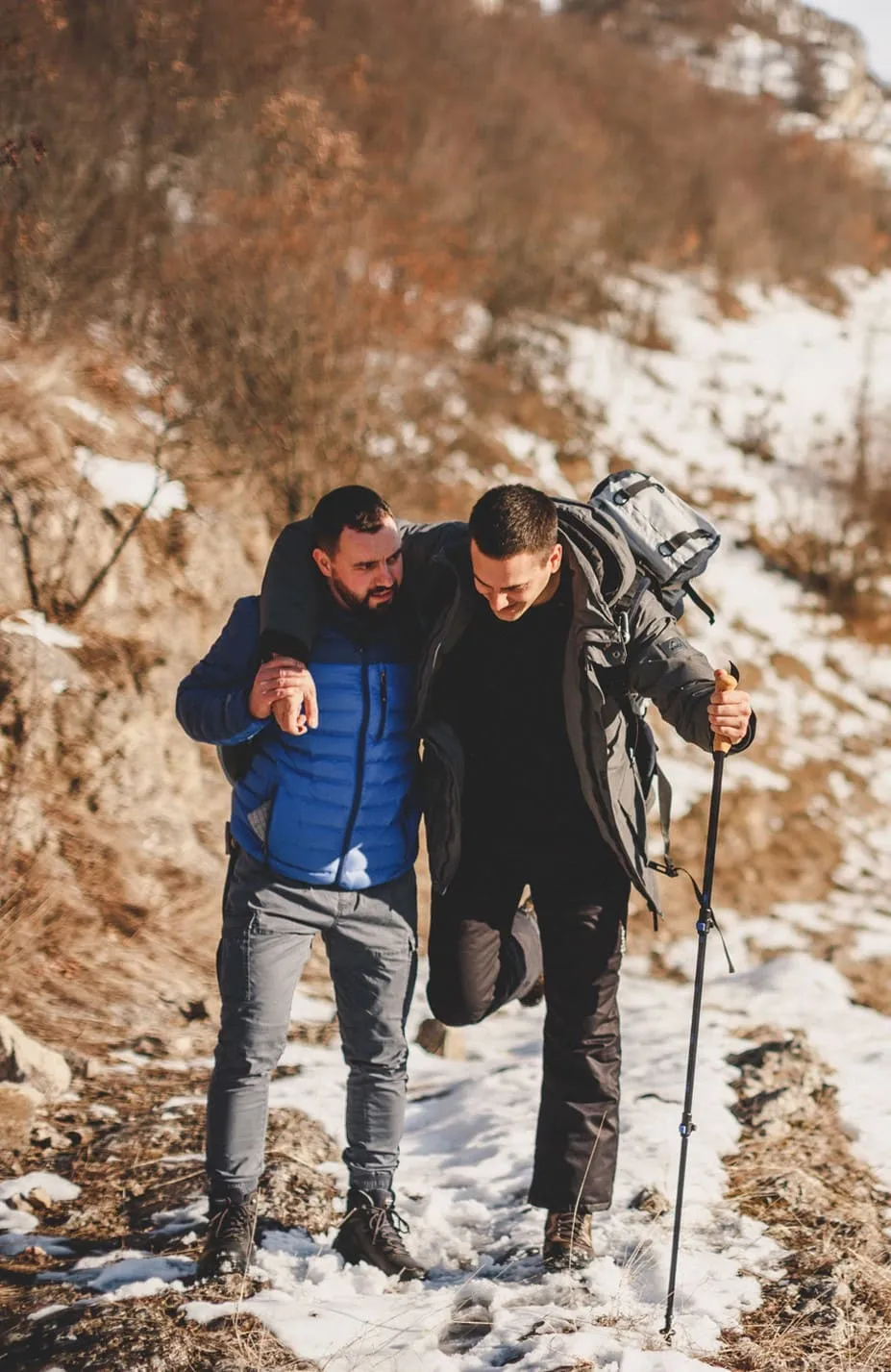 Man helping his friend walking