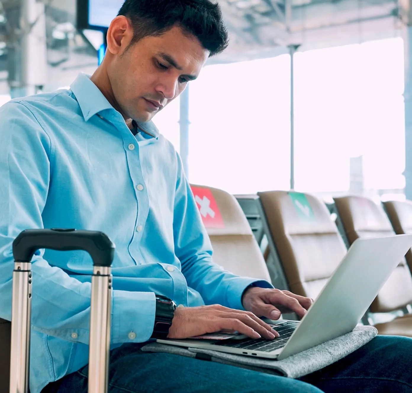 Man working on his laptop at airport