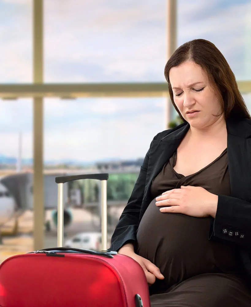 Pregnant woman waiting with baggage