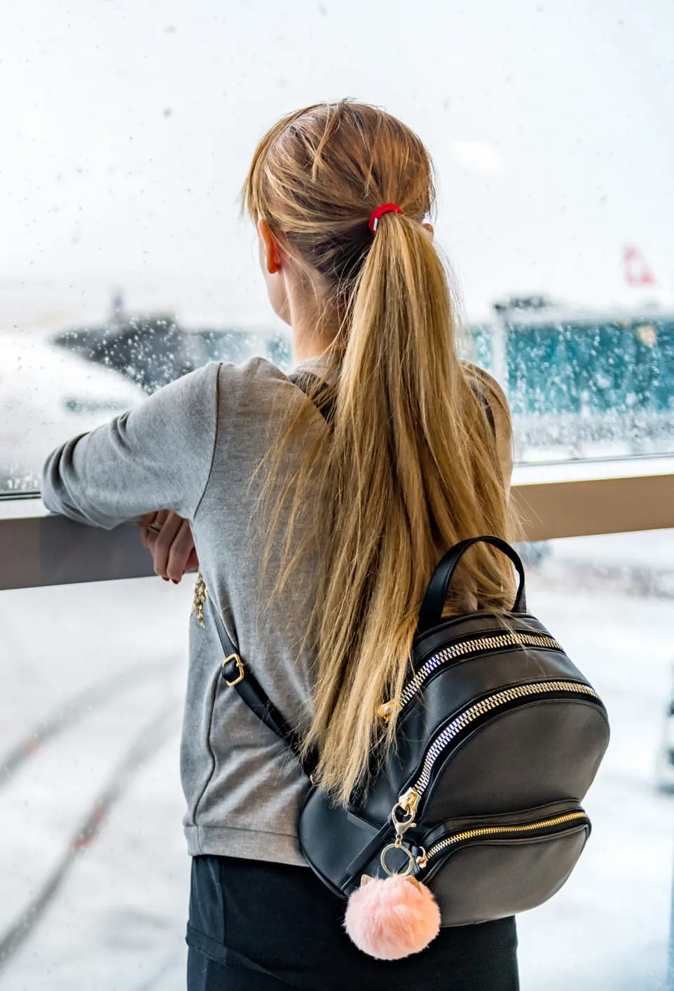 Woman looking at airplane departure